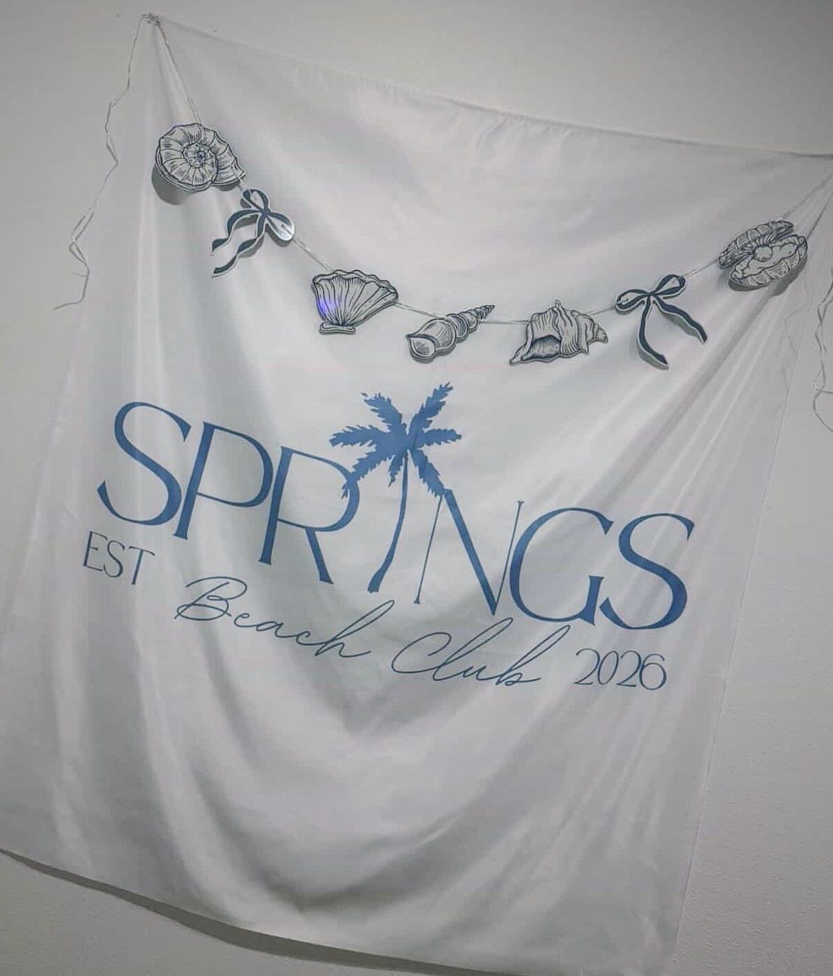 Springs Beach Club fabric banner with shells and palm
