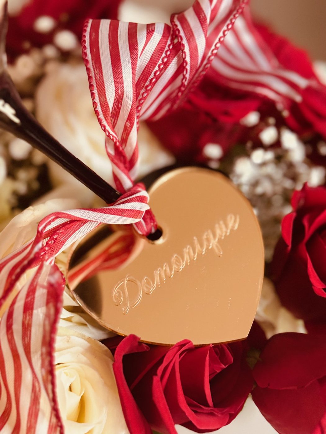 Gold mirror heart drink charm on a martini glass