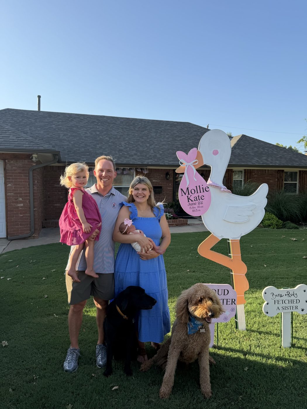 Stork yard sign installed for a new baby